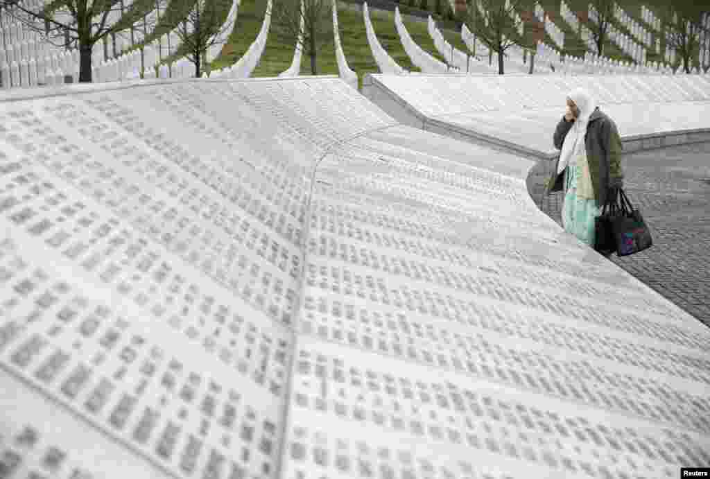 A woman stands near a grave of her family members in the memorial center Potocari before a judge announces the verdict on former Bosnian Serb political leader Radovan Karadzic's appeal of his 40-year sentence for war crimes, near Srebrenica, Bosnia and Herzegovina.