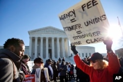 Lesa Curtis of Westchester, N.Y., (R), who is pro agency fees and a former president of her union, rallies outside the Supreme Court in Washington, Jan. 11, 2016.