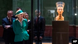 FILE - Queen Margrethe II of Denmark looks at the bust of Nefertiti, as she visits the New Museum in Berlin, Sept. 10, 2014.