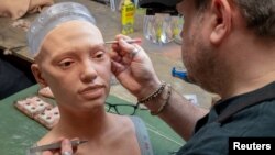 The rubberised head of Ai-Da, a humanoid robot capable of drawing people from life using her bionic eyes and hand, is given lifelike features by Mike Humphrey, a specialist at robotics company Engineered Arts, in Falmouth, Cornwall, Britain February 7, 20