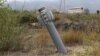 An unexploded projectile of multiple rocket launcher stuck into land near a settlement in self-proclaimed Republic of Nagorno-Karabakh, Azerbaijan, Oct. 1, 2020.