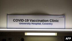 A sign in the Covid-19 Vaccination Clinic at the University Hospital in Coventry, central England is pictured on Dec. 4, 2020, prior to the NHS administering jabs to the most vulnerable early next week.