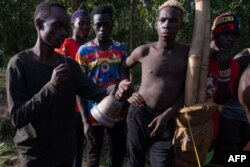 FILE—A young man rings a bell to start a match as members of Uganda's Soft Ground Wrestling prepare for a training session on February 28, 2024.