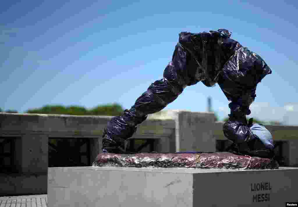 The statue of Argentina&#39;s soccer player Lionel Messi is seen covered after it was vandalized in Buenos Aires.