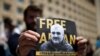 FILE - A man attends a rally to support an Azerbaijani journalist Afgan Mukhtarli, who was abducted in Tbilisi on May 29, then held in detention in Baku, in Tbilisi, Georgia, May 31, 2017.