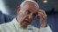 Pope Francis gestures during a news conference on board the plane during his flight back from a trip to Chile and Peru, Jan. 22, 2018. 
