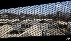FILE - A view through a mesh window looks out over part of Aden Central Prison, known as Mansoura, in this May 9, 2017, photo in Aden, Yemen. A section of the prison is run by Yemeni allies of the United Arab Emirates.