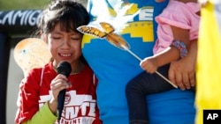 FILE - In this June 18, 2018 file photo, Akemi Vargas, 8, cries as she talks about being separated from her father during an immigration family separation protest in front of the Sandra Day O'Connor U.S. District Court building in Phoenix.