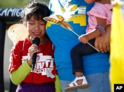 FILE - Akemi Vargas, 8, cries as she talks about being separated from her father during an immigration family separation protest in front of the Sandra Day O'Connor U.S. District Court building in Phoenix, June 18, 2018.