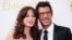 FILE - Actress Zooey Deschanel, from the Fox sitcom "New Girl," arrives with Jacob Pechenik at the 66th Primetime Emmy Awards in Los Angeles, California.