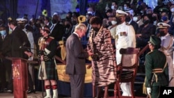 Barbados' new President Sandra Mason, center right, awards Prince Charles with the Order of Freedom of Barbados during the presidential inauguration ceremony in Bridgetown, Barbados on Nov. 30, 2021.