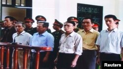 FILE - Six democracy activists stand at dock in Hai Phong City's People's Court in Hai Phong, about 100 kilometers east of Hanoi, Oct. 2009. From L-R: Nguyen Van Tuc, Nguyen Van Tinh, Nguyen Manh Son, Nguyen Kim Nhan, Nguyen Xuan Nghia (2nd R), Ngo Quynh.