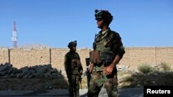 Afghan security forces inspect the site of a suicide bomb attack in Kabul, October 2, 2014.