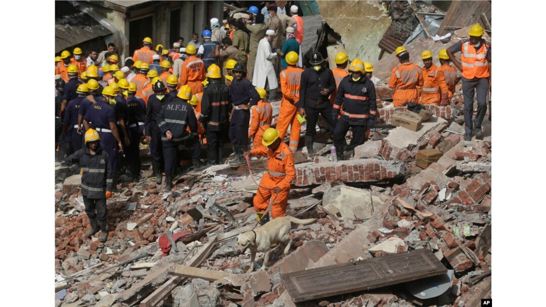 Rescuers work at the site of a building collapse in Mumbai, India, Aug. 31, 2017.