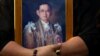 FILE - A mourner holds a portrait of Thailand's late King Bhumibol Adulyadej in Bangkok, Thailand, Oct. 14, 2016. 