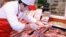A staff member at a Taipei hyper market examines imported US beef, (File Photo). 