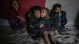 Palestinian children sit inside their family's tent at a camp for internally displaced Palestinians on the beachfront in Deir al-Balah, central Gaza Strip, Dec. 27, 2024. 