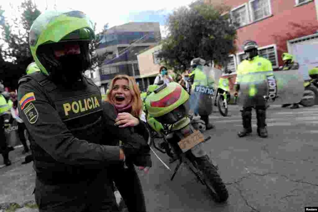 A demonstrator is detained by police officers, during a protest calling for dignified life, amidst an outbreak of the coronavirus disease (COVID19), in Bogota, Colombia, June 15, 2020.