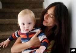 FILE - Fulvia Serra and her husband, Scott, are raising their 1-year-old son, Sebastiano, vegan. Despite criticism and innuendo from some circles, pediatricians and nutritionists agree it's perfectly healthy to feed babies a vegan diet.
