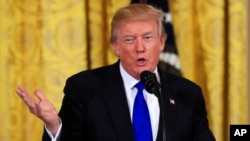 FILE - President Donald Trump speaks to a gathering of mayors in the East Room of the White House in Washington, Jan. 24, 2018. 