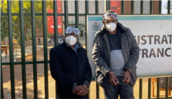 Transform Zimbabwe’s Jacob Ngarivhume and reporter Hopewell Chin’ono outside Harare Magistrates Court on July 22, 2020 in Harare. (Photo: Columbus Mavhunga/VOA)