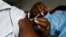 FILE - A man receives a vaccine against the COVID-19 at a mobile vaccination center in Abidjan, Ivory Coast, Sept. 23, 2021. 