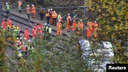 Members of the emergency services work next to a tram after it overturned injuring and trapping some passengers in south London, Nov. 9, 2016. 