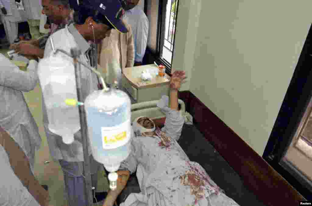 A man who was injured after an explosion in a Shi'ite mosque receives first aid at a hospital in Shikarpur, Sindh province, Pakistan, Jan. 30, 2015.