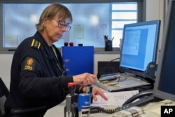 Chief Customs officer Nina Bullock was handling traditional paper clearance forms, Feb. 8 2019, as her computer informed her of an incoming truck using a new digital customs clearance system that allows transporters to drive through customs without stoppiing.