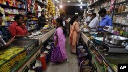 Indian people shop at a store in Mumbai, India, Friday, Sept. 14, 2012.