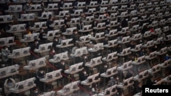 Traders wearing face masks are seen on the trading floor at a flower auction trading center following an outbreak of the novel coronavirus in the country, in Kunming, Yunnan province, China, Feb. 10, 2020.