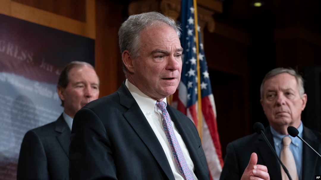 Sen. Tim Kaine, D-Va., center, joined at by Sen. Tom Udall, D-N.M., left, and Sen. Dick Durbin, D-Ill., speak after the Senate approved a bipartisan measure limiting President Trump's authority to launch military operations against Iran, Feb. 13, 2020.