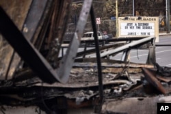 A Theatre Palisades stands next to the theater destroyed by the Palisades Fire, in the Pacific Palisades neighborhood of Los Angeles, Calif., Jan. 25, 2025.