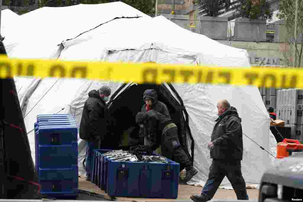 Workers construct what is believed to be a makeshift morgue behind a hospital during the coronavirus pandemic, in the Manhattan borough of New York City.