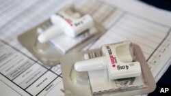 FILE - A Narcan nasal device lies on a counter as a health educator gives instructions on how to administer it, Brooklyn, New York, July 3, 2018.