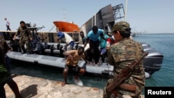 Illegal migrants arrive at a naval base after they were rescued by Libyan coastguard in the coastal city of Tripoli, Libya, May 6, 2017. 