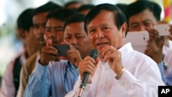 Cambodian Vice President of the National Assembly Kem Sokha, also vice president of Cambodia National Rescue Party, foreground, delivers a speech during a Buddhist ceremony to mark 18th anniversary in Phnom Penh, Cambodia, Monday, March 30, 2015.