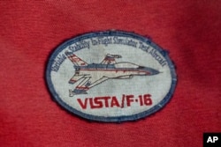 A patch for the X-62A Variable Stability In-Flight Simulator Test Aircraft, VISTA, aircraft, part of DARPA's Air Combat Evolution (ACE) program, is seen on Wednesday, May 1, 2024, at Edwards Air Force Base, Calif. (AP Photo/Damian Dovarganes)