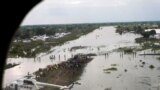 FILE - A World Food Program helicopter is seen on a flooded airstrip after heavy rains and floods forced hundreds of thousands of people to leave their homes, in Pibor, Boma state, South Sudan, Nov. 6, 2019.