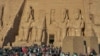  Tourists gather to as the beam from the rising sun hits the innermost sanctuary to illuminate the statues of king Ramses II, his wife Nefertari, and God Amun Re. (Hamada Elrasam/VOA)