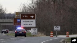 A Maryland State Police cruiser sits at a blocked southbound entrance on the Baltimore-Washington Parkway that accesses the National Security Agency, March 30, 2015, in Fort Meade, Md.