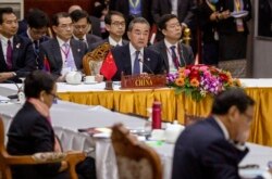 China's Foreign Minister Wang Yi, center back, attends the Special ASEAN-China Foreign Ministers' meeting on the Novel Coronavirus Pneumonia in Vientiane, Laos, Thursday, Feb. 20, 2020.