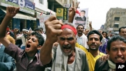 Anti-government protestors shout slogans during a demonstration demanding the resignation of Yemeni President Ali Abdullah Saleh, in Taiz, Yemen, Sunday, June 19, 2011.