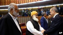 Pakistani legislators greet Turkey's President Recep Tayyip Erdogan, right, after his address at the parliament in Islamabad, Pakistan, Thursday, Nov. 17, 2016. 