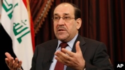 FILE - In this Dec. 3, 2011, file photo, Iraq's Shiite Prime Minister Nouri al-Maliki talks during an interview with The Associated Press in Baghdad, Iraq