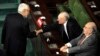 Tunisian Islamist Ennahda party leader Rached Ghannouchi (L) greets former Prime Minister Rachid Sfar (C) as former President Fouad Mbazaa (R) looks on, during a special session of the National Constituent Assembly (NCA), on October 23, 2012 in Tunis.