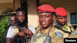 FILE - Burkina Faso's new military leader Ibrahim Traore is escorted by soldiers in Ouagadougou, Burkina Faso, Oct. 2, 2022.