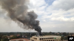 FILE - Heavy smoke rises from the Westgate Mall in Nairobi, Kenya, after multiple large blasts rocked the facility during an assault by security forces, Sept. 23, 2013, in response to a terrorist attack.