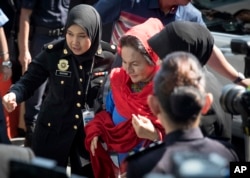 FILE - Rosmah Mansor, center, wife of former Malaysian prime minister Najib Razak, arrives at the country's Anti-Corruption Agency for questioning in Putrajaya, Malaysia, June 5, 2018.