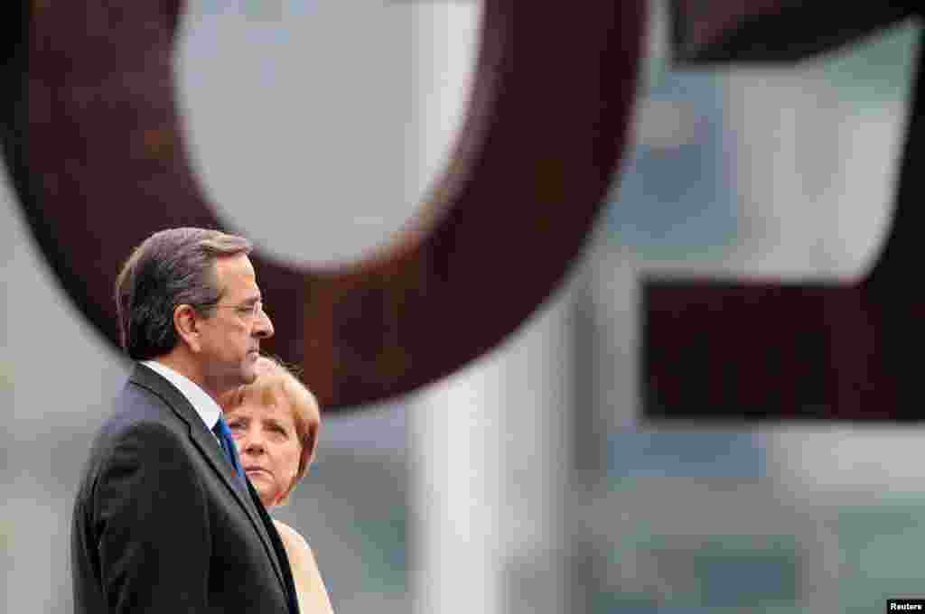August 24: German Chancellor Angela Merkel and Greek Prime Minister Antonis Samaras before talks in Berlin to discuss Greece&#39;s fiscal crisis. 